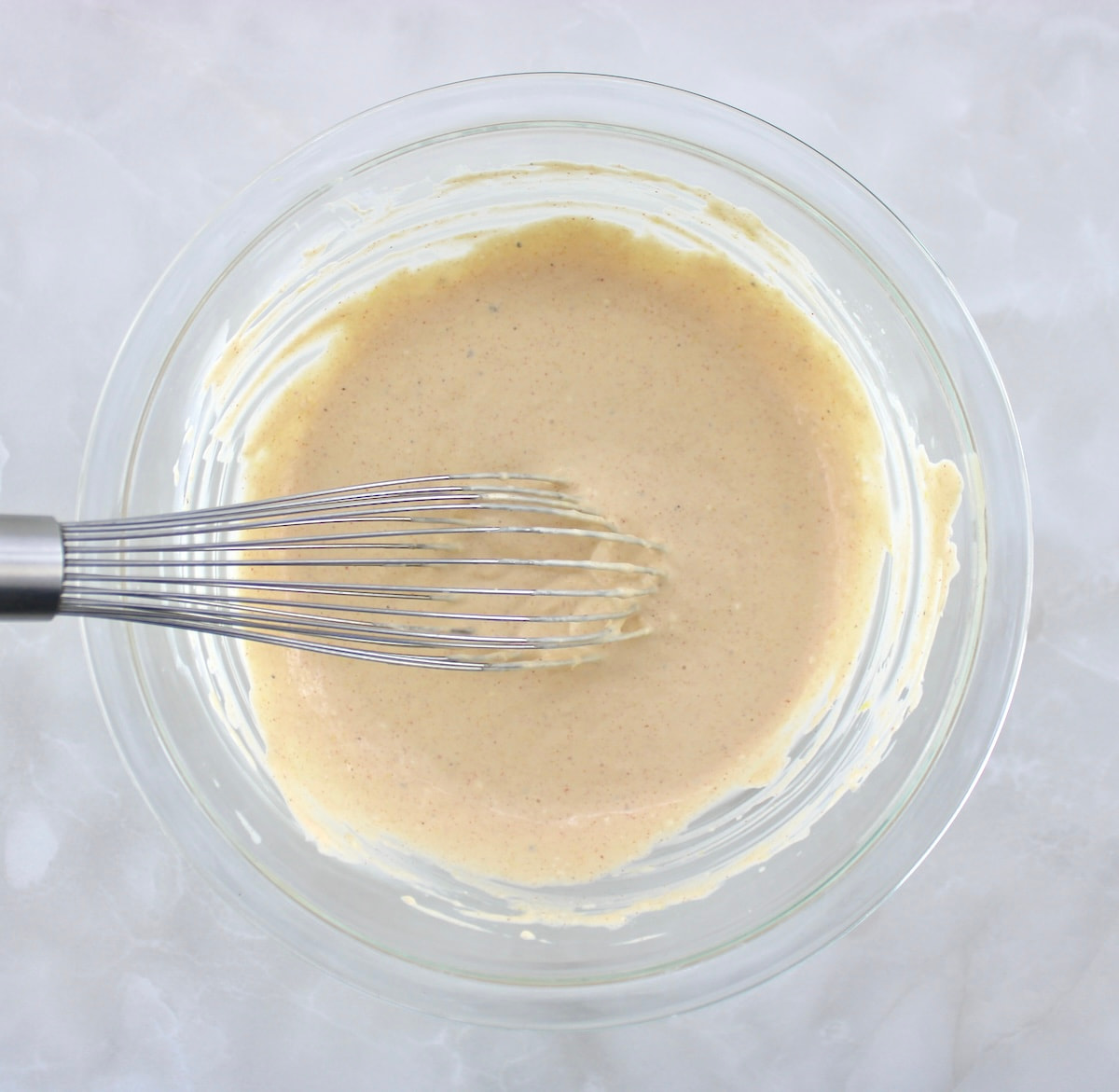 Cold Crab Dip dressing in glass bowl with whisk