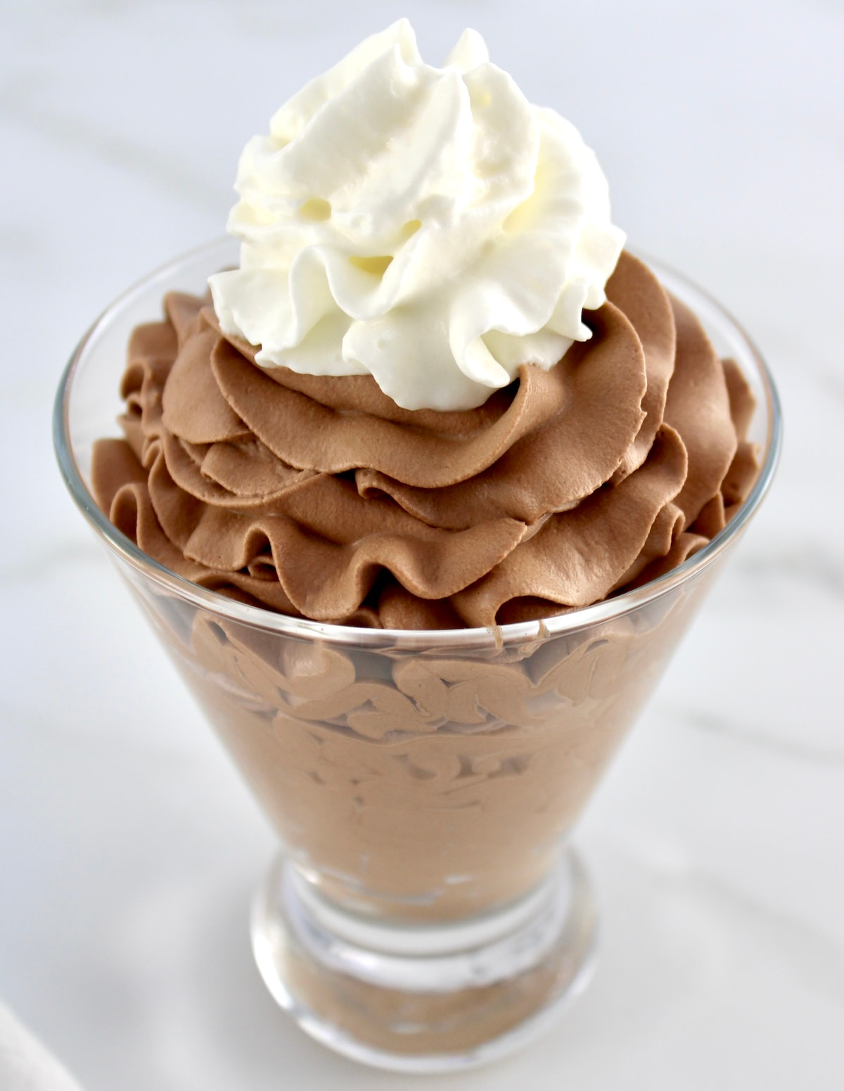 fluffy swirls of chocolate moussed with whipped cream topping