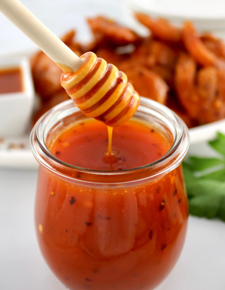 vertical image of glass jar filled with hot honey sauce