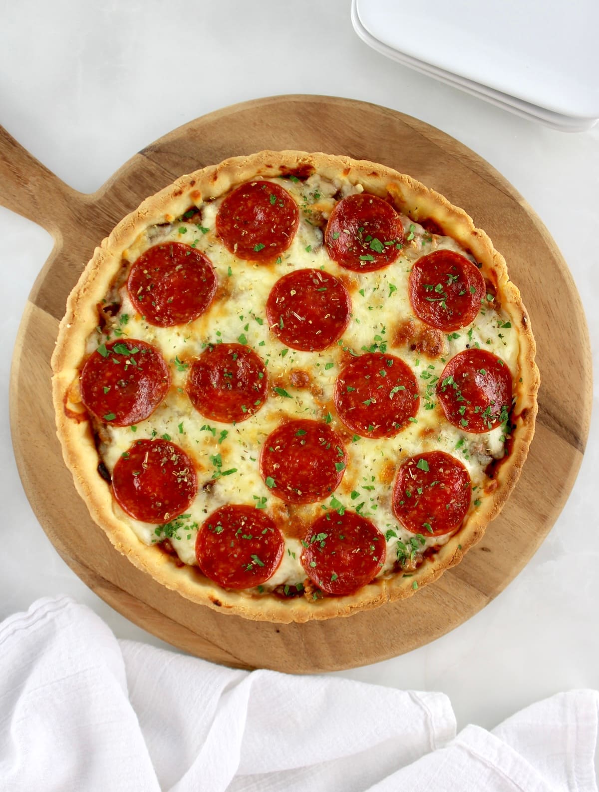 overhead view of Keto Sausage and Pepperoni Pizza Pie on pizza peel