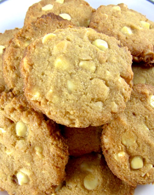 keto white chocolate macadamia cookies piled up on white plate