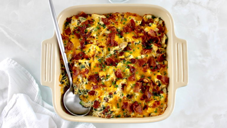 overhead view of Bacon Ranch Chicken Casserole in baking dish with silver serving spoon