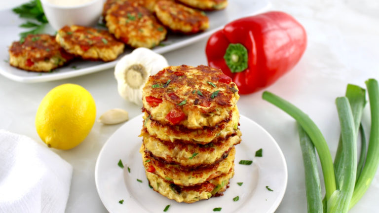 stack of chicken fritters on white platter