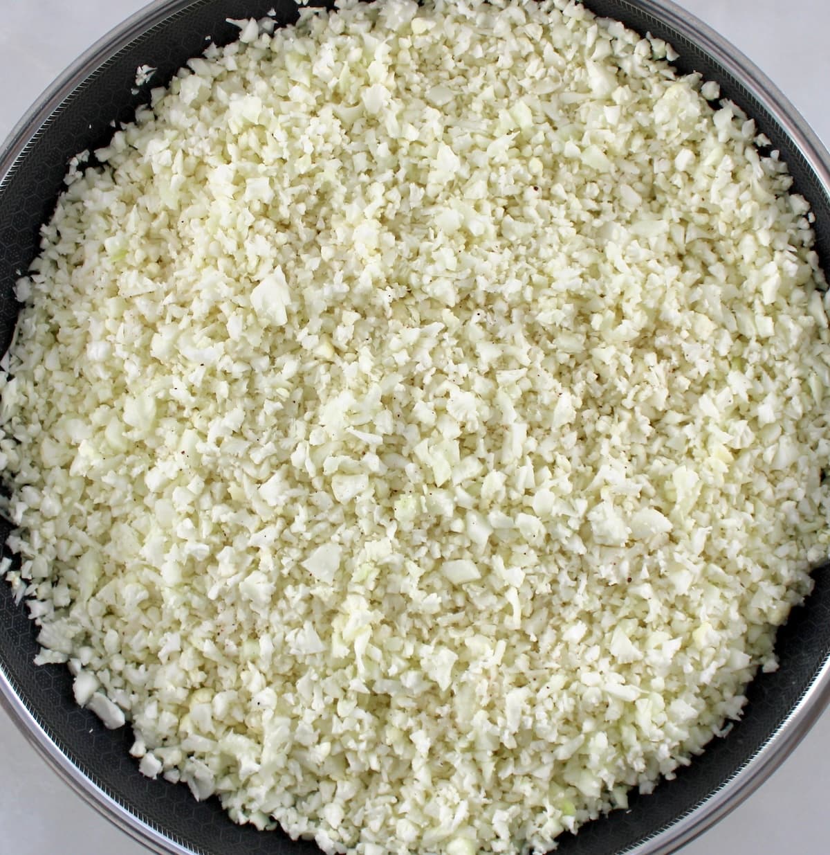 cauliflower rice cooking in skillet