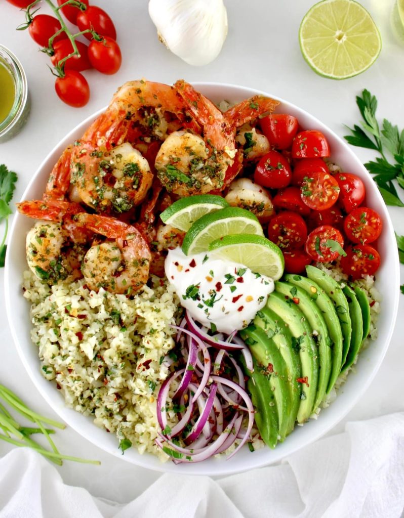 Chimichurri Shrimp Avocado Bowl with sour cream and chopped cilantro on top