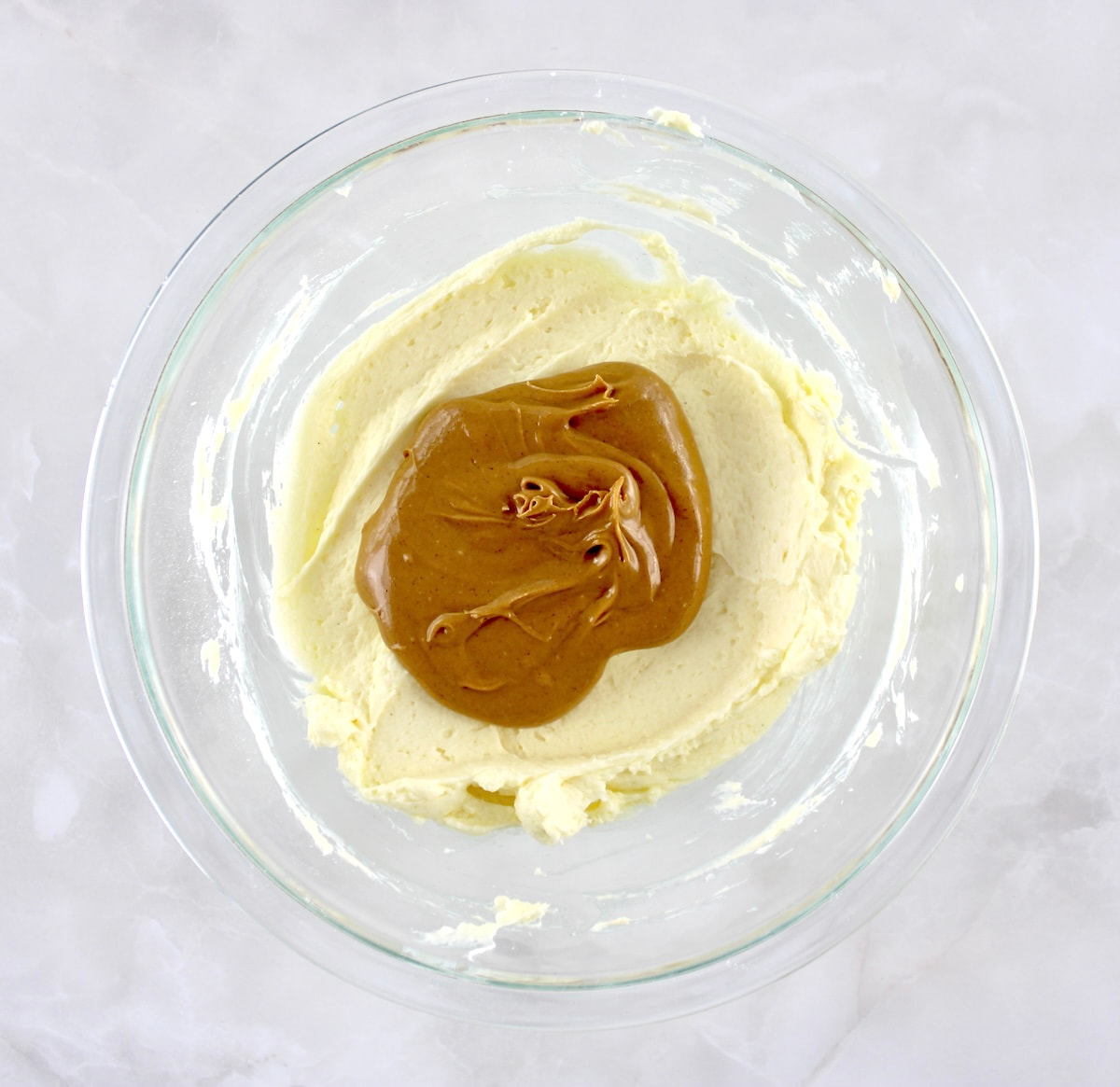 Keto Peanut Butter Frosting ingredients in glass bowl unmixed