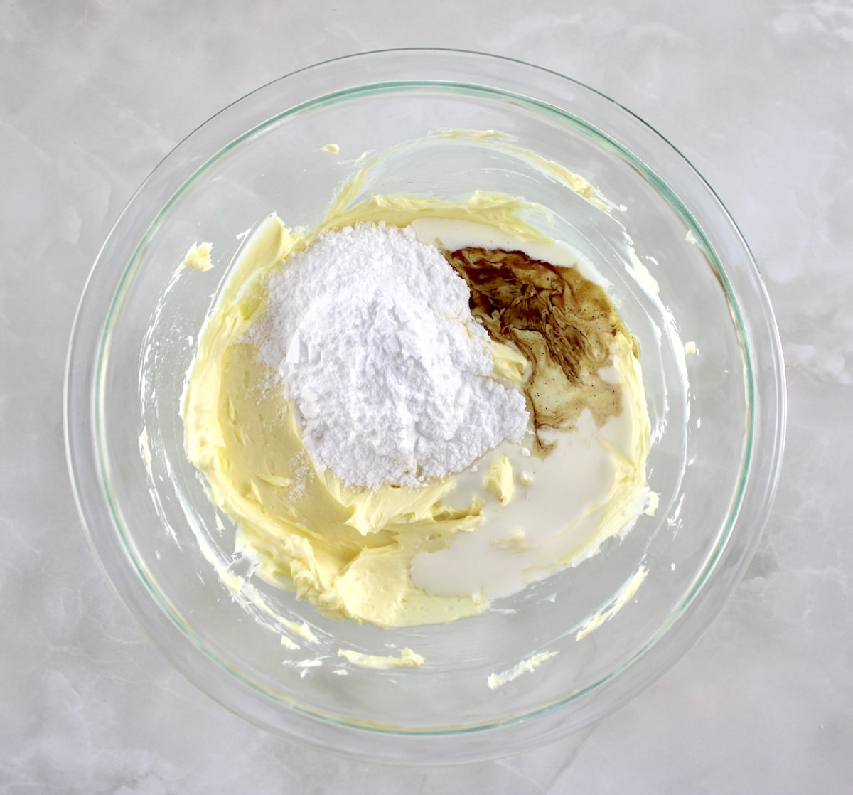 Keto Peanut Butter Frosting ingredients in glass bowl unmixed