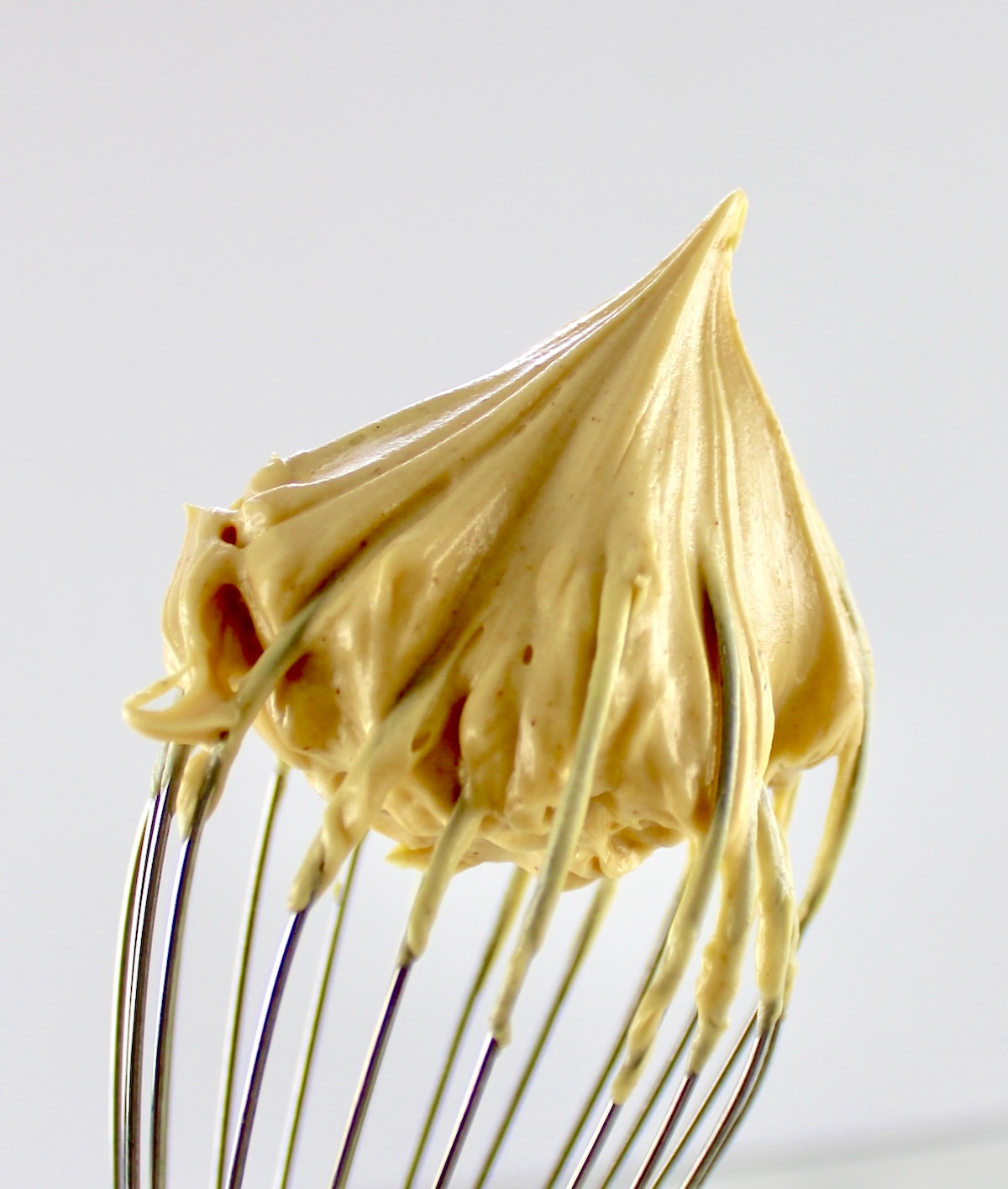 closeup of Keto Peanut Butter Frosting on whisk