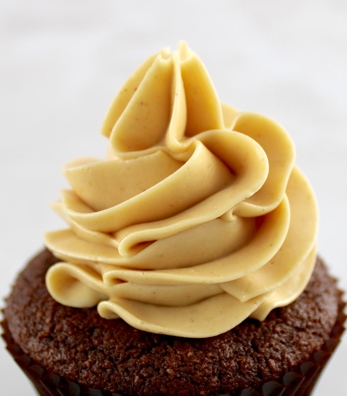 closeup of Keto Peanut Butter Frosting on chocolate cupcake