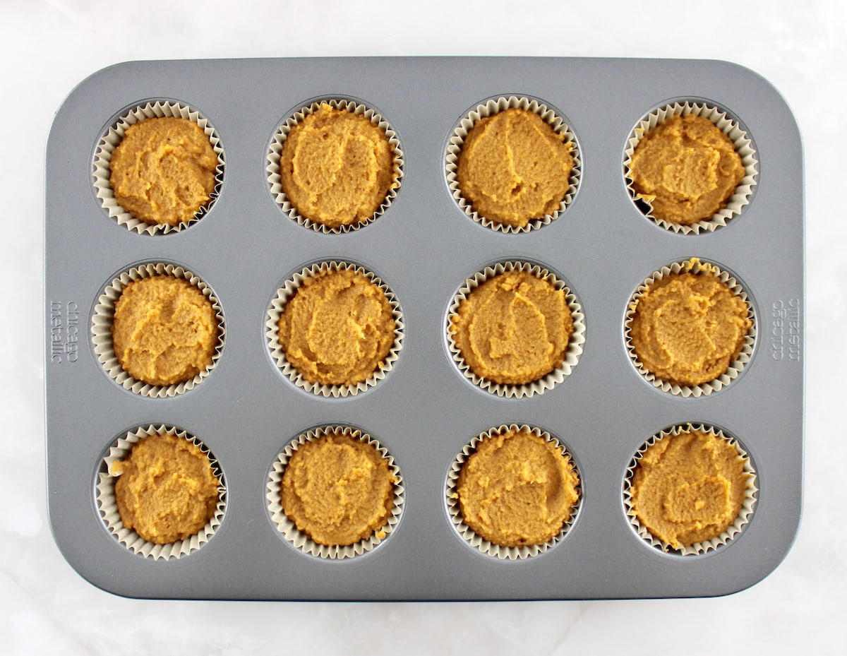 Keto Pumpkin Coffee Cake Muffin batter in muffin pan unbaked
