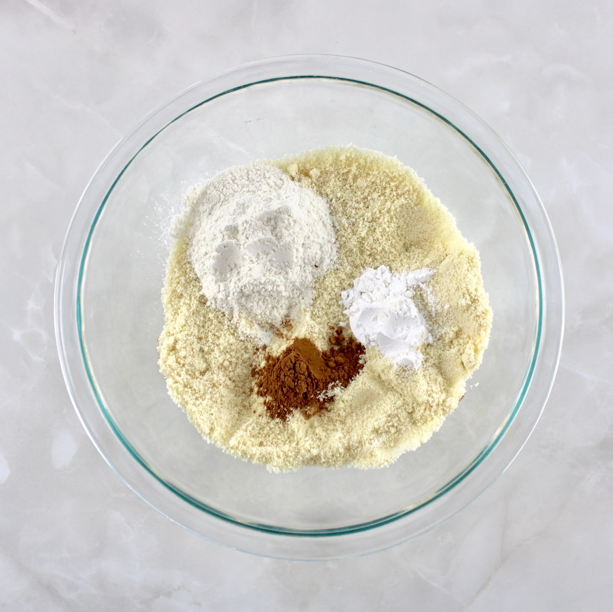 Keto Pumpkin Coffee Cake Muffins dry ingredients in glass bowl unmixed