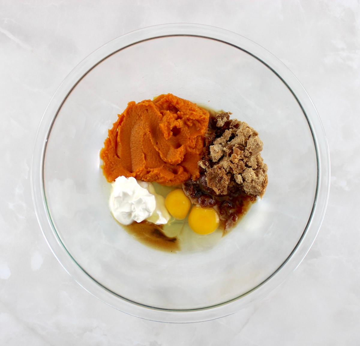 Keto Pumpkin Coffee Cake Muffins wet ingredients in glass bowl unmixed