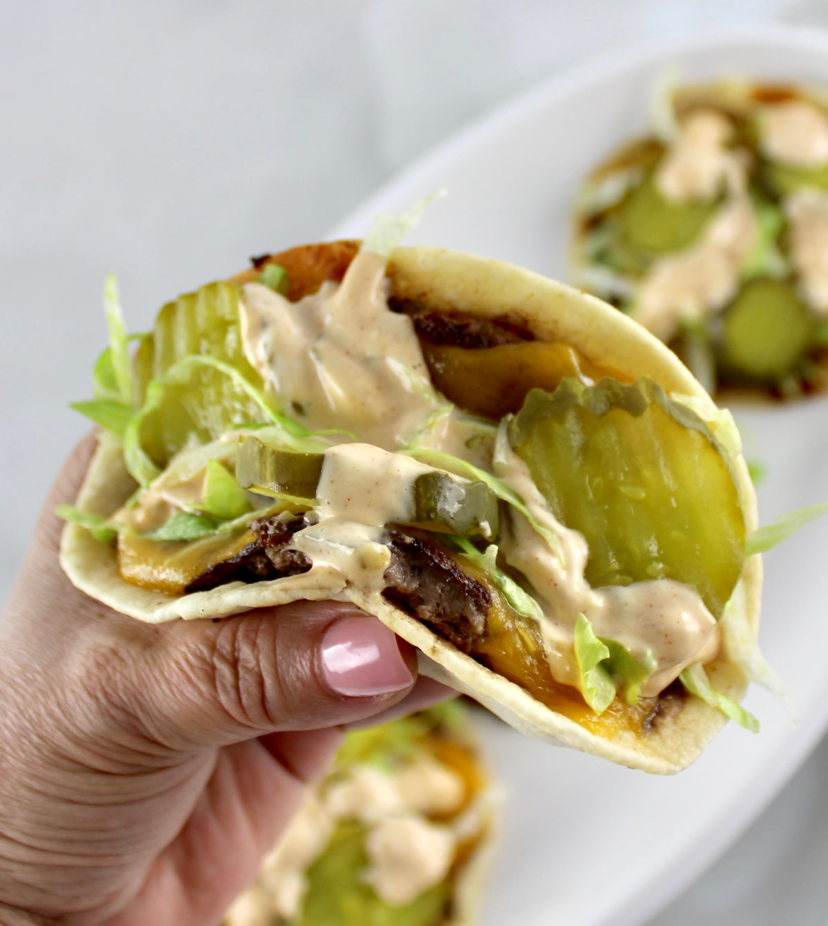 holding up Keto Smash Burger Taco