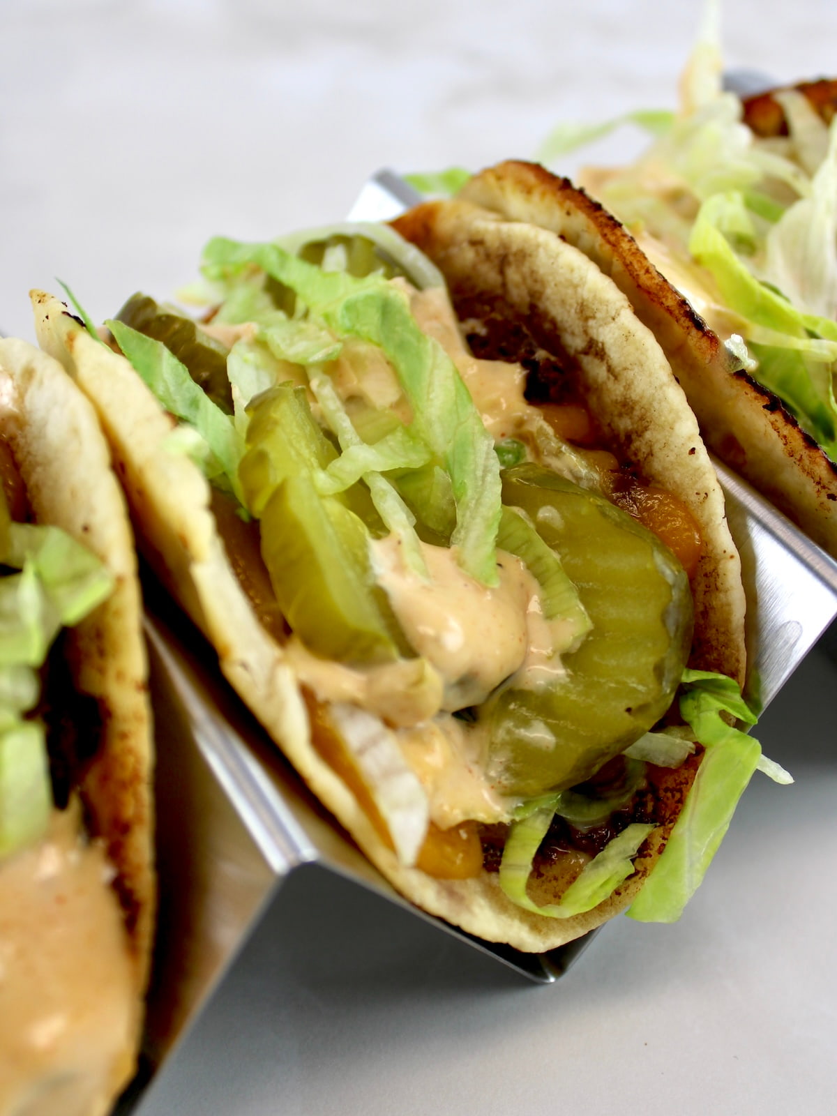 closeup of Keto Smash Burger Taco in metal taco rack