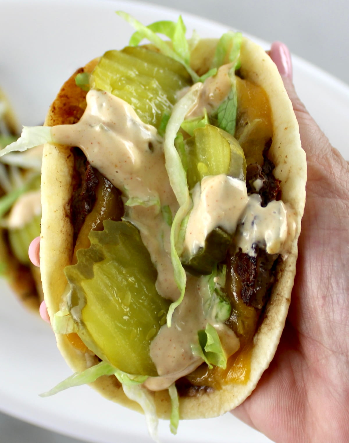 closeup of holding Keto Smash Burger Taco in hand