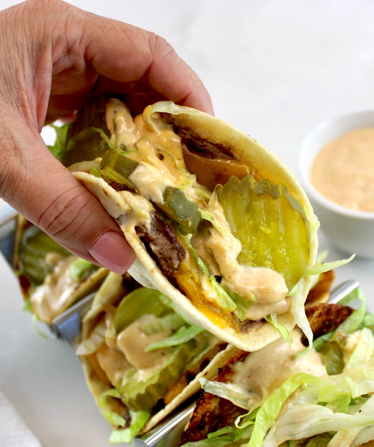 holding up Keto Smash Burger Taco