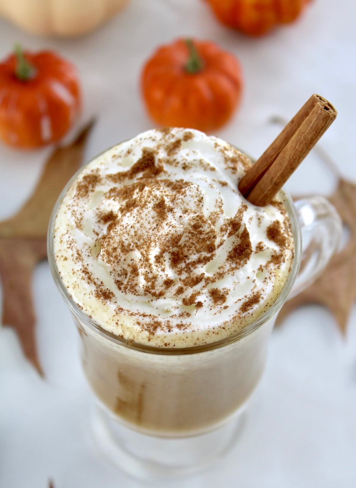 overhead view of Pumpkin Spiced Bulletproof Coffee in glass mug with whip cream on top