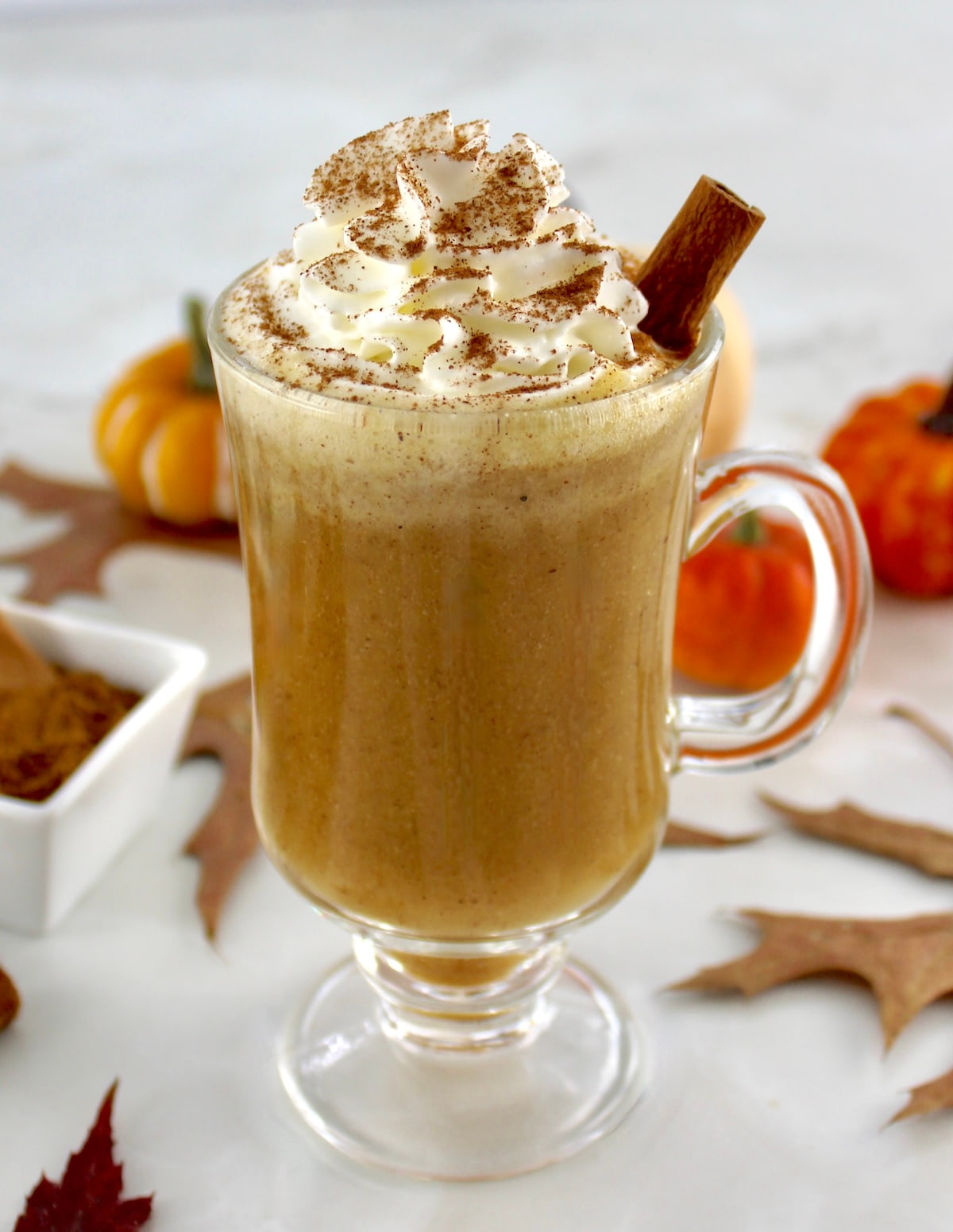 side view of Pumpkin Spiced Bulletproof Coffee in glass mug with whip cream