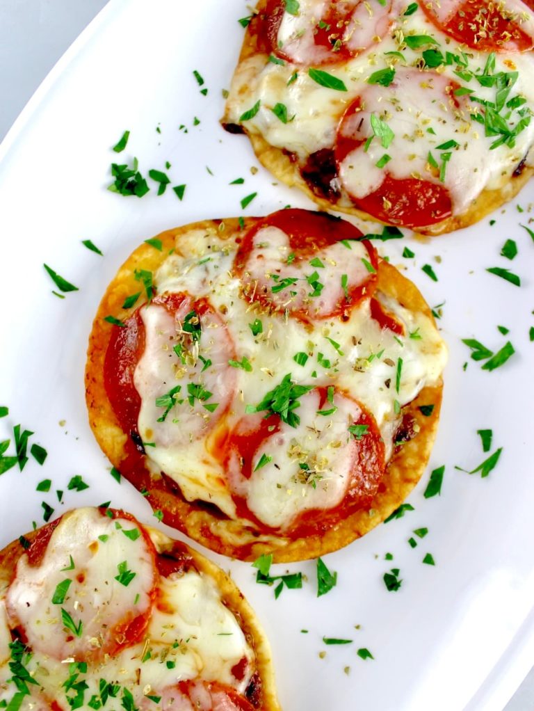 overhead view of Smash Burger Pizza Tacos on white plate with fresh parsley