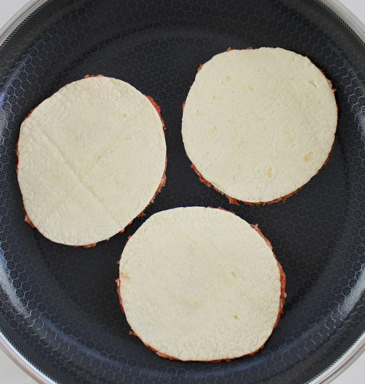 3 Smash Burger Pizza Tacos cooking in skillet