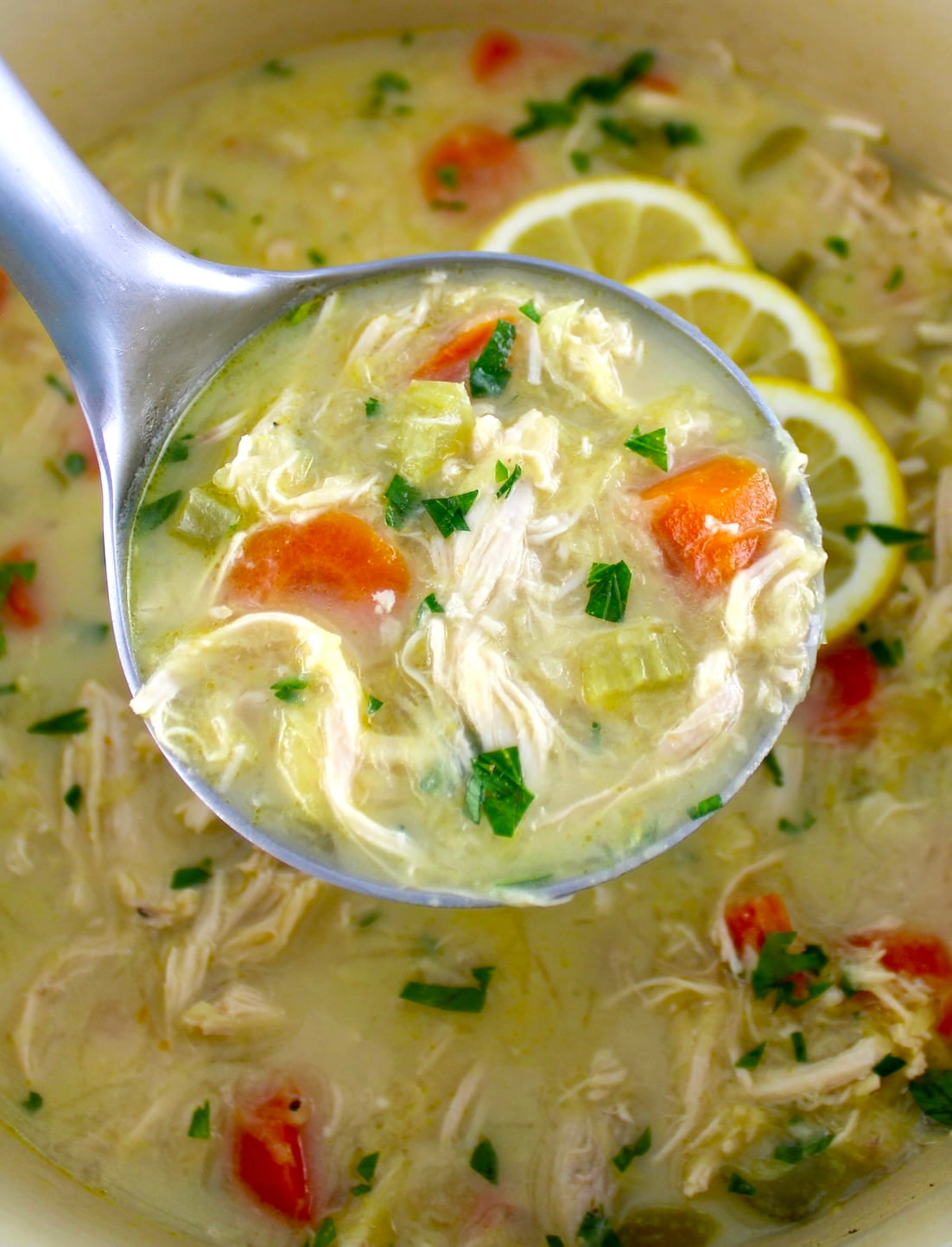 Avgolemono Soup in ladle held up over pot