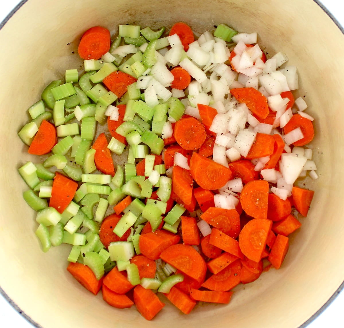 chopped carrots, onions and celery in pot uncooked