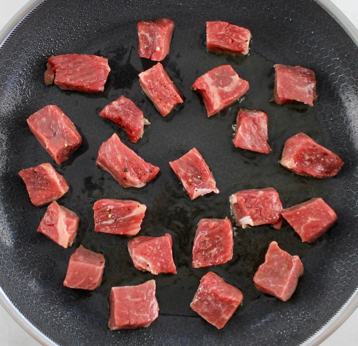 steak cut into cubes in skillet