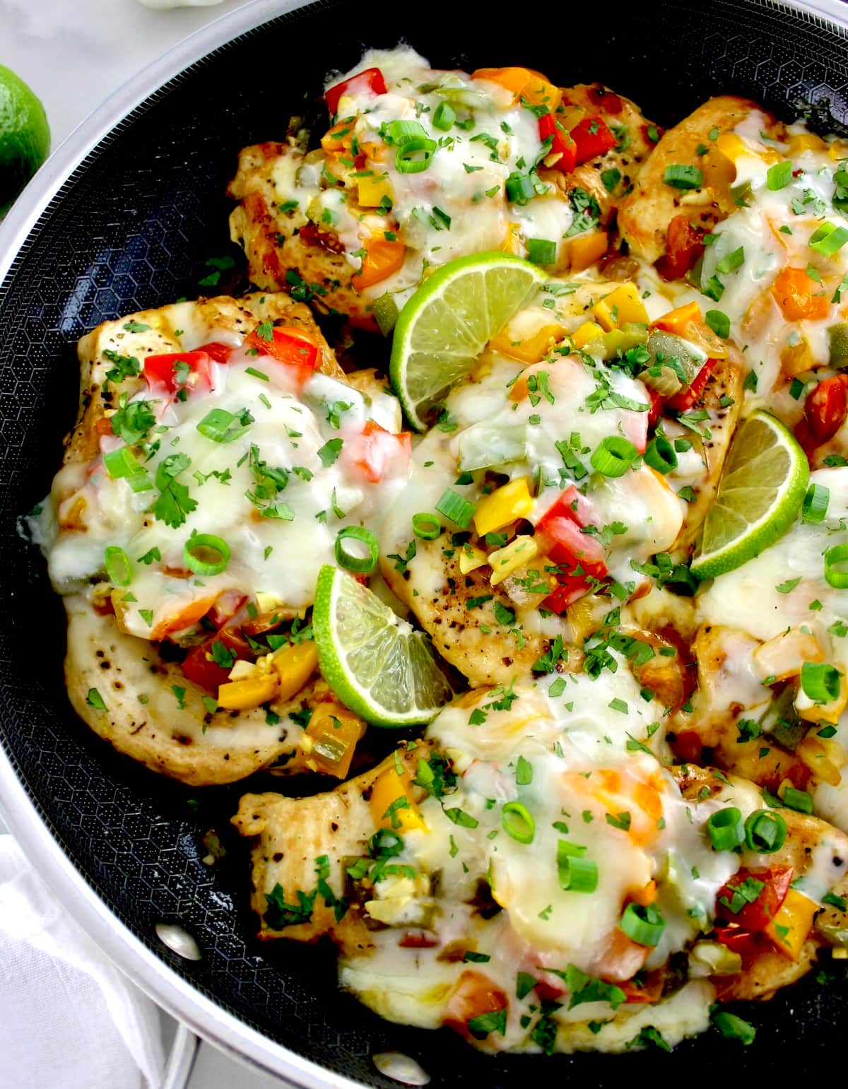 closeup of Fiesta Chicken Skillet with lime slices and chopped cilantro