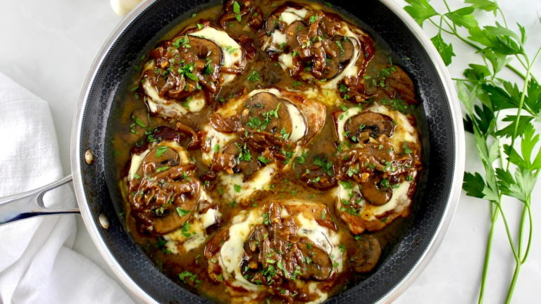 6 pork chops in a pan smothered with french onion toppings