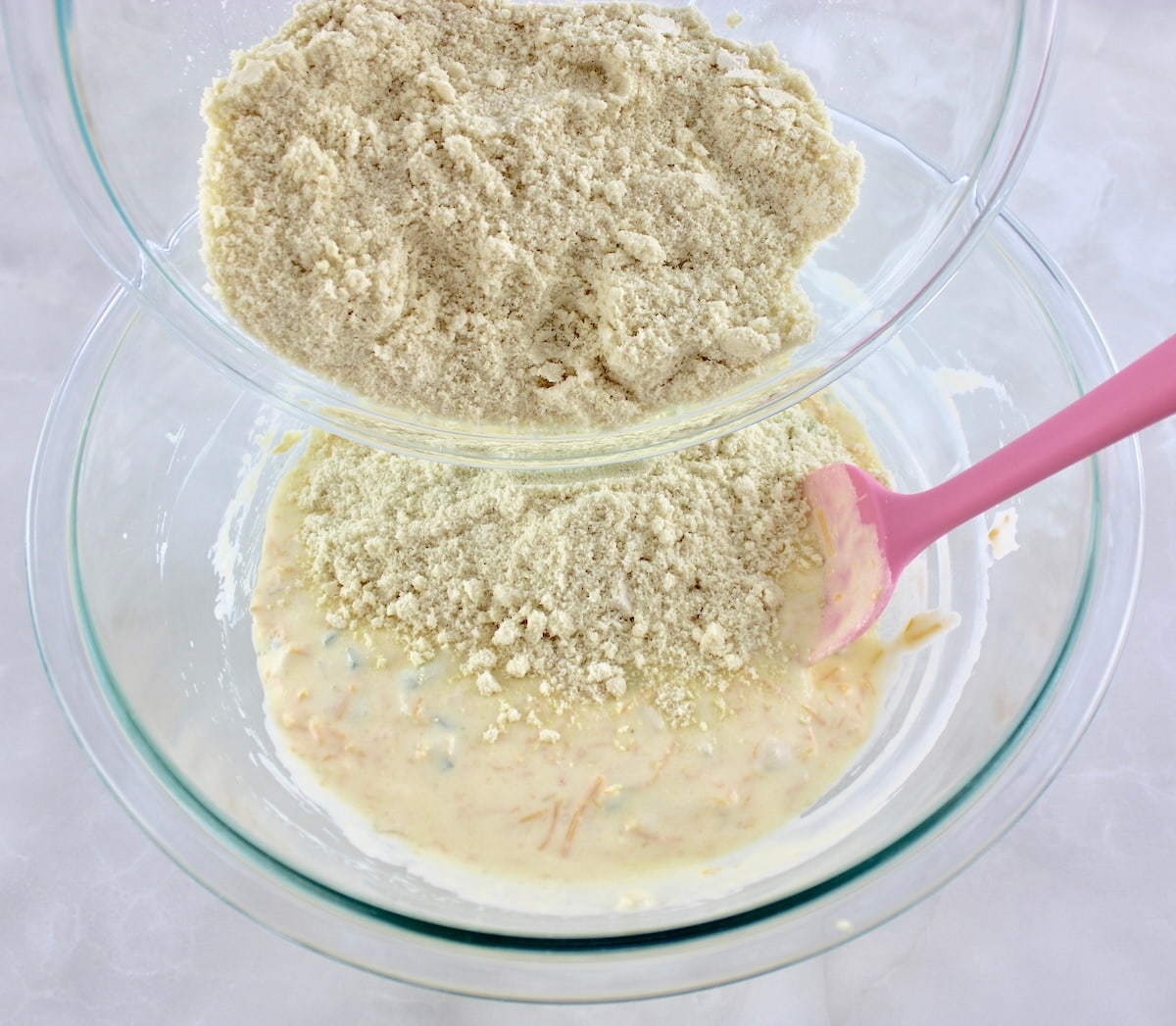 Keto Cheddar Jalapeño Cornbread dry ingredients being poured into wet ingredients