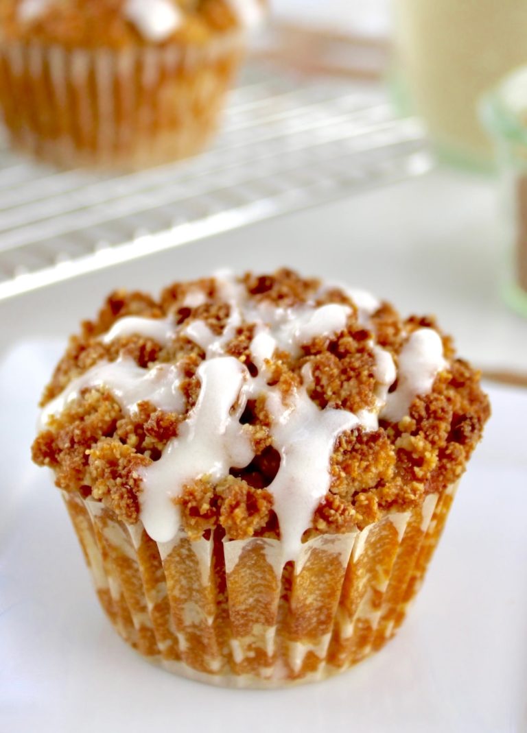 Keto Pumpkin Coffee Cake Muffin on white plate with icing drizzle on top