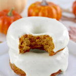 closeup of 2 Keto Pumpkin Donuts stacked and bite taken out of top donut
