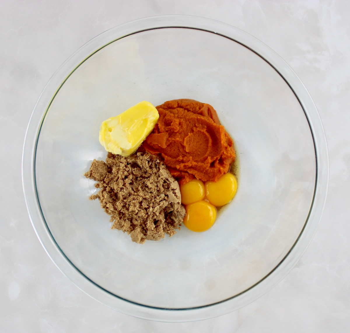 wet ingredients for Keto Pumpkin Donuts in glass bowl unmixed