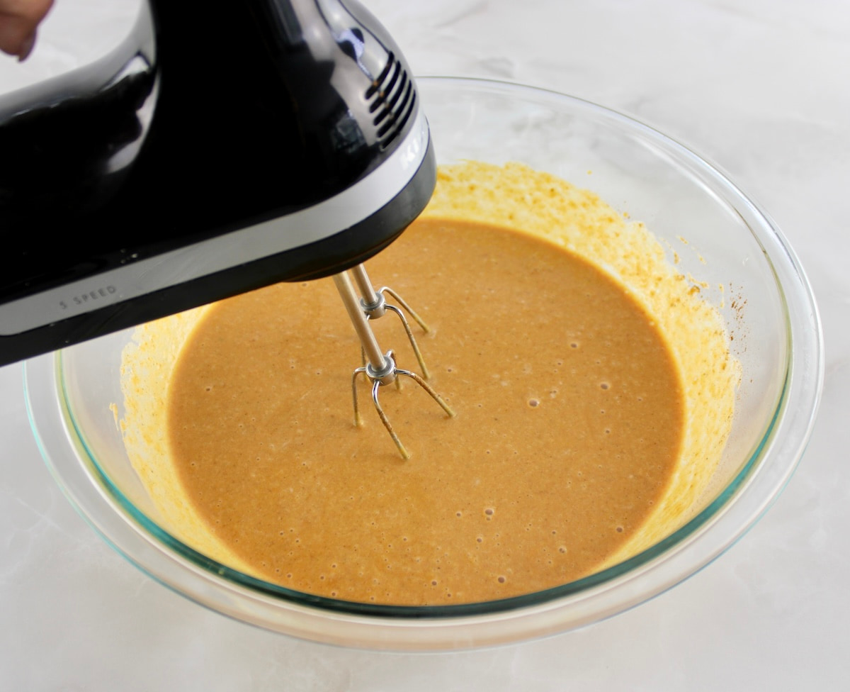 Keto Pumpkin Pie filling ingredients being mixed with hand mixer