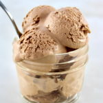 3 scoops of Mason Jar Chocolate Ice Cream in open jar with spoon