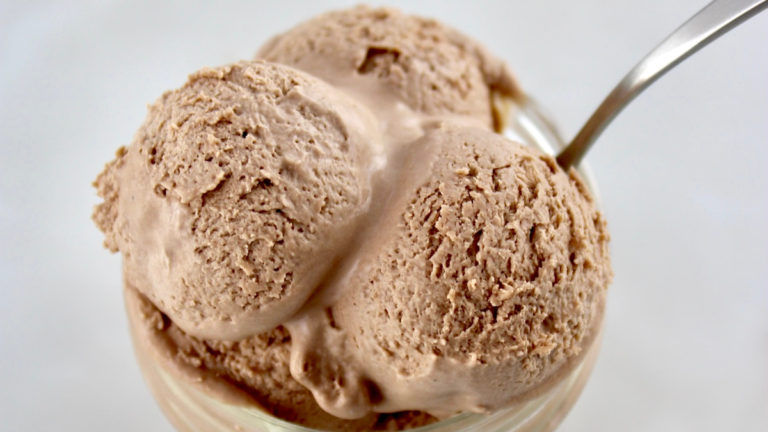 closeup of 3 scoops of Mason Jar Chocolate Ice Cream in open jar with spoon