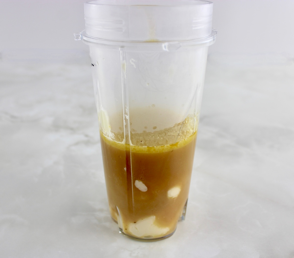 beef broth and cream cheese in bullet blender cup