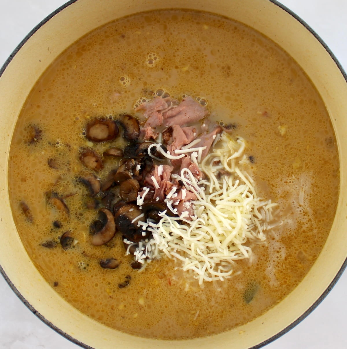 Philly Cheesesteak Soup with mushrooms, cheese and roast beef on top