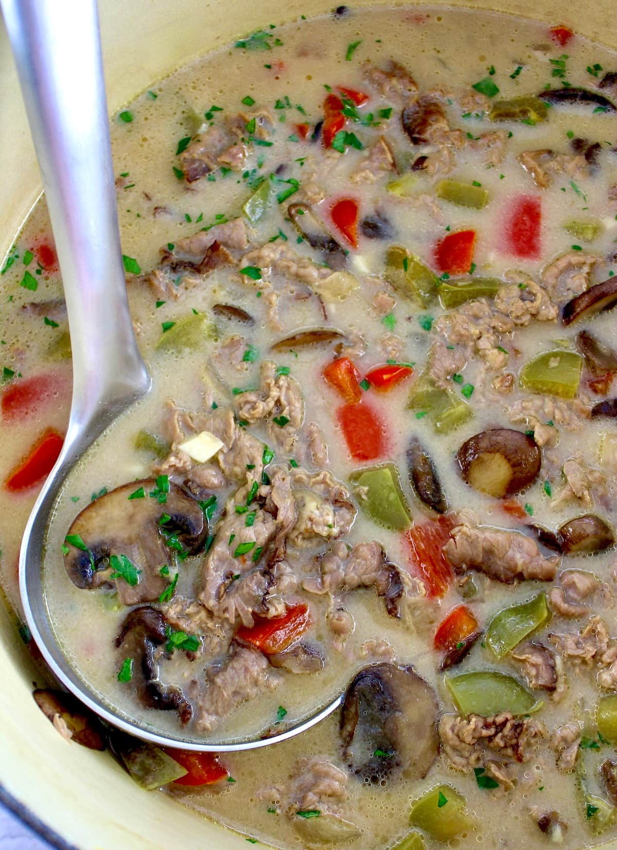 Philly Cheesesteak Soup in dutch oven with ladle on side