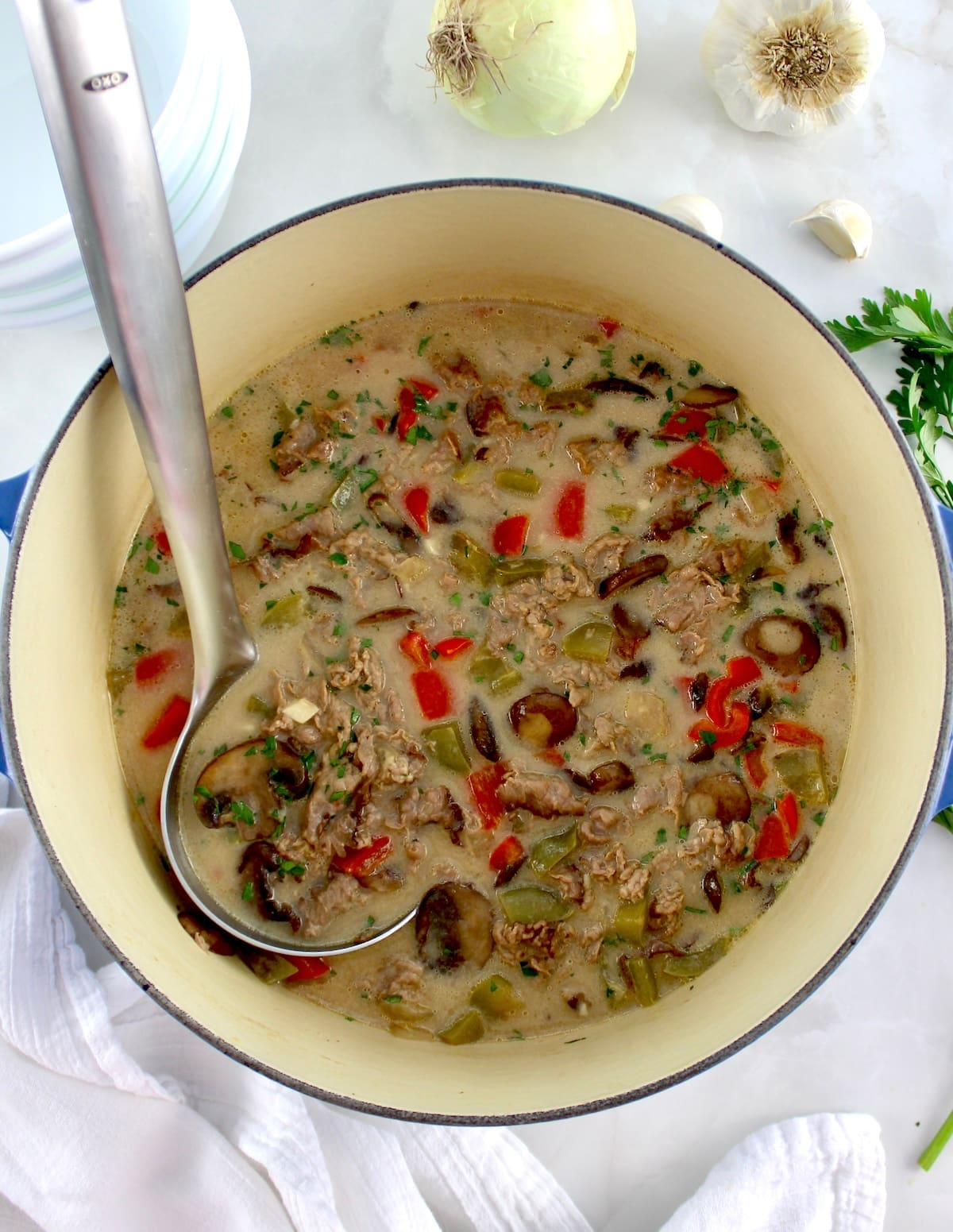 Philly Cheesesteak Soup in dutch oven with ladle on side