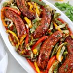 Sheet Pan Sausage and Peppers on white oval platter