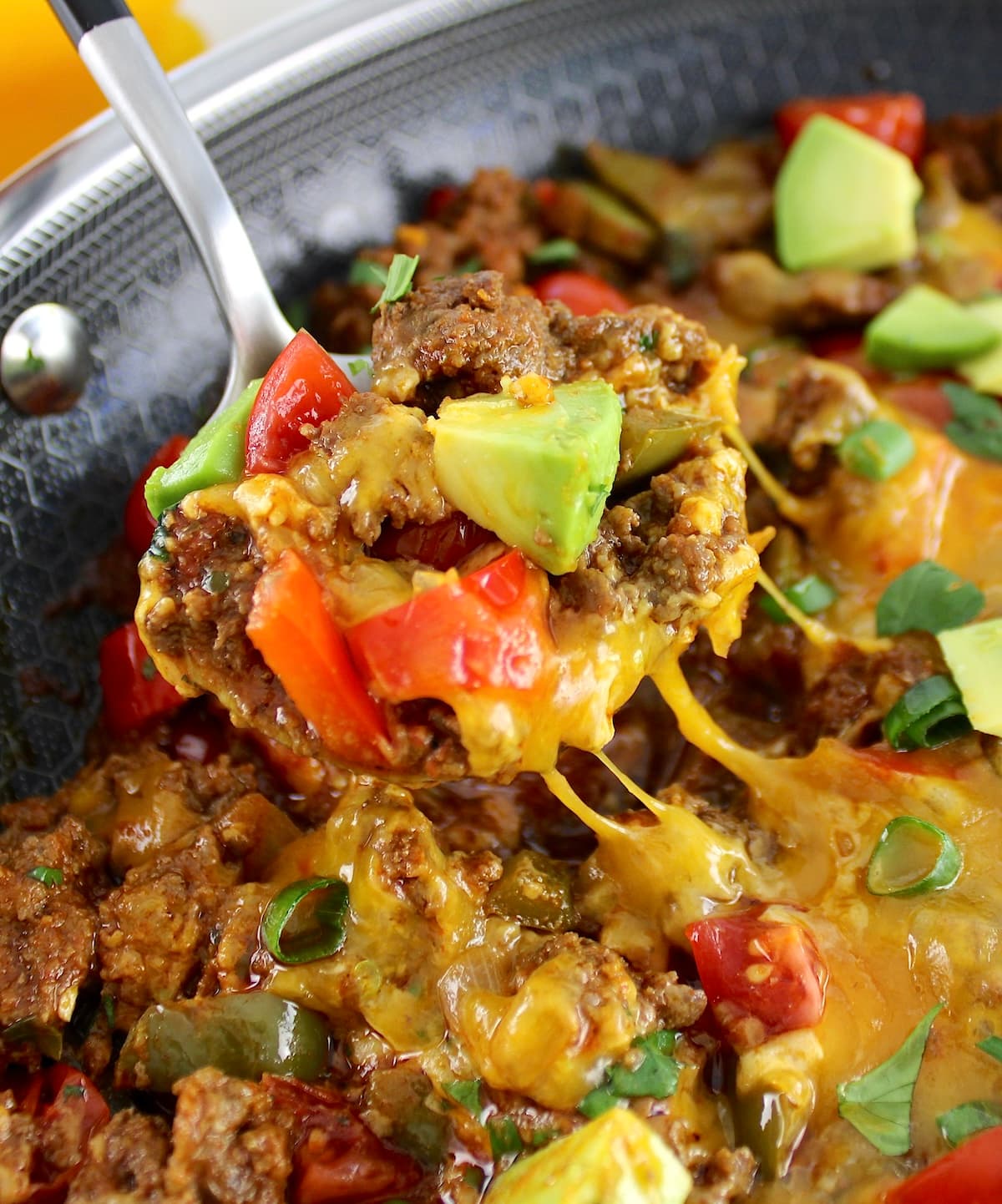 closeup of spoon scooping some Taco Skillet out of skillet