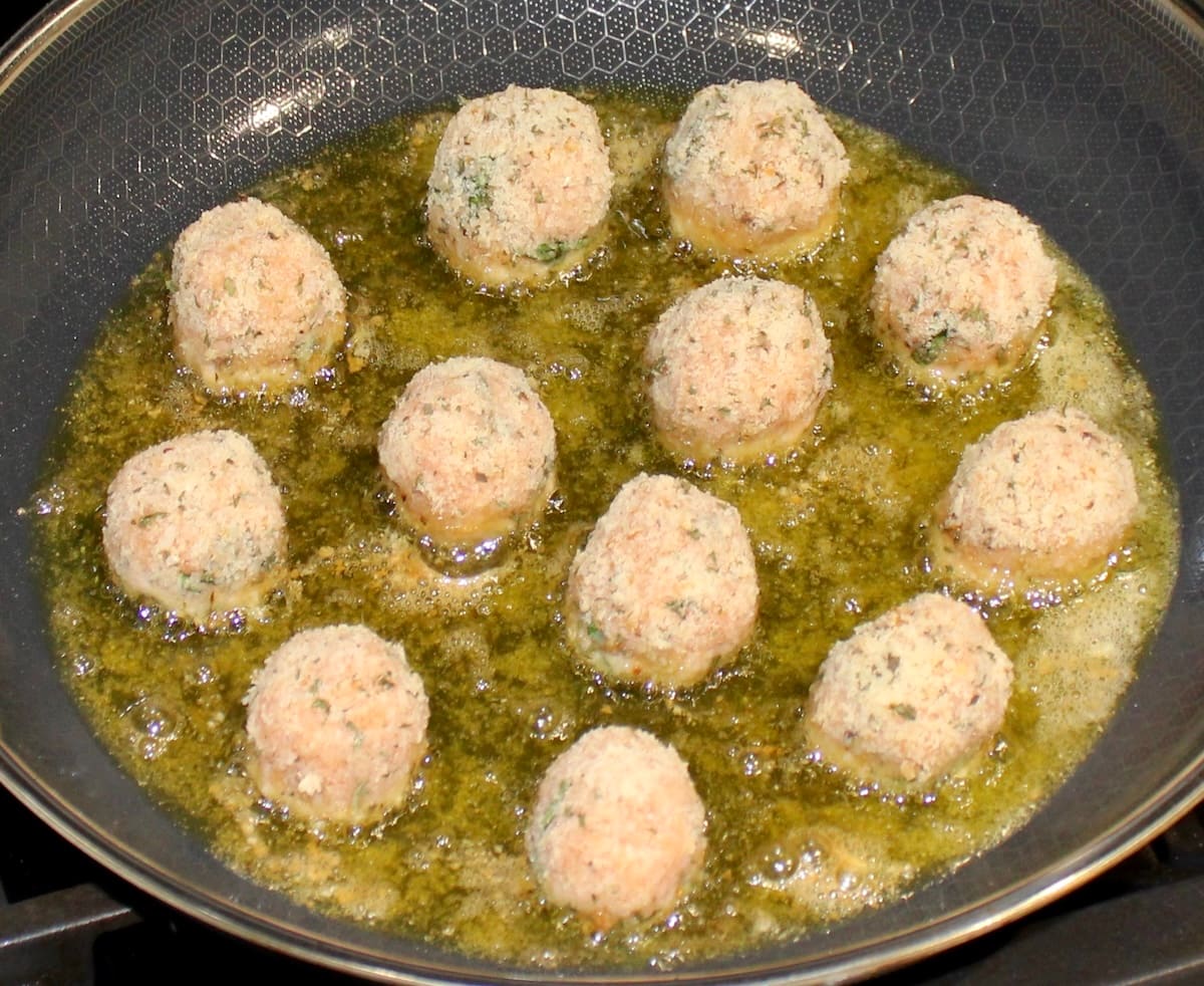 Chicken Parmesan Meatballs frying in skillet with olive oil