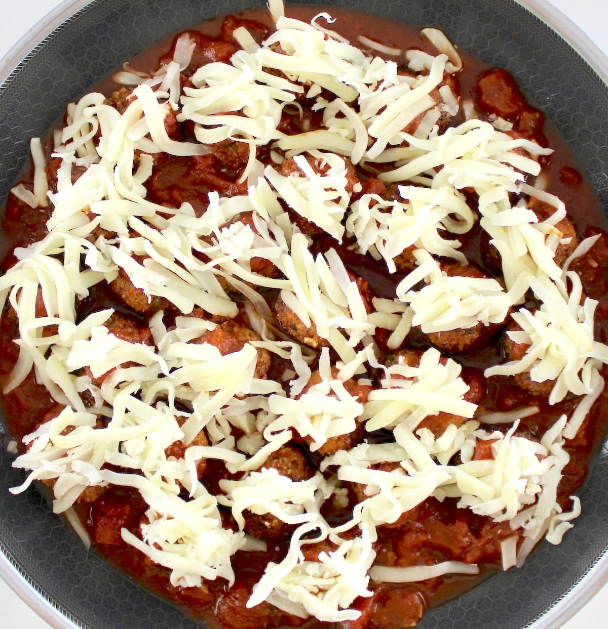 Chicken Parmesan Meatballs with shredded mozzarella cheese over the tops unmelted