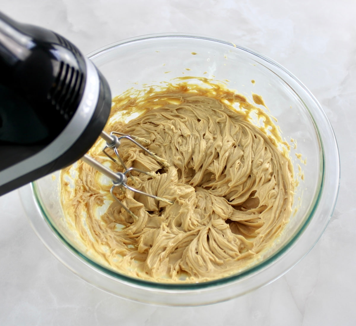 Chocolate Peanut Butter Truffles filling ingredients in glass bowl being mixed with hand mixer