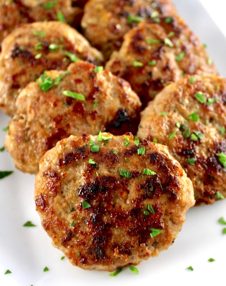 Homemade Breakfast Sausage patties on white plate with chopped parsley