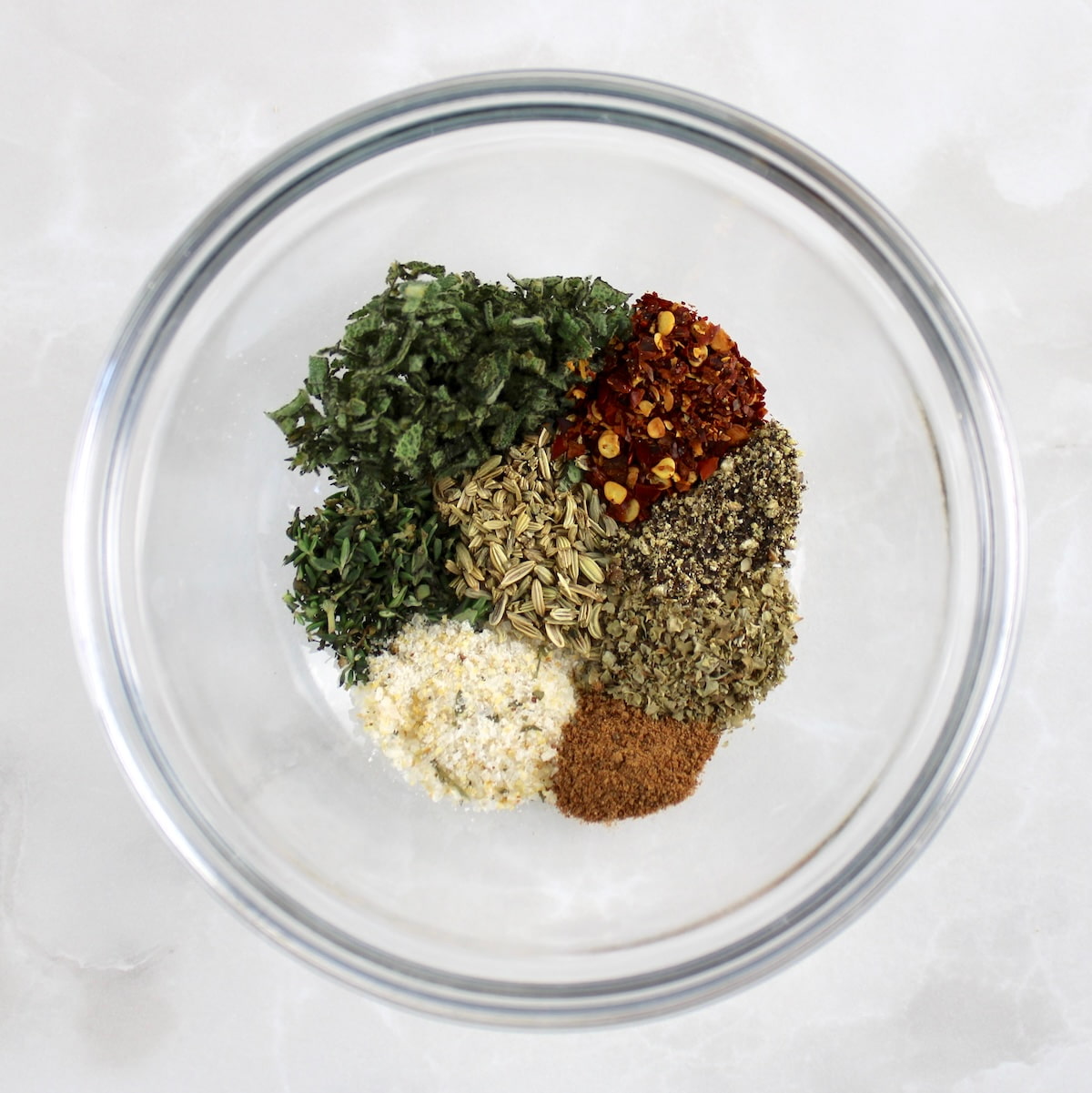 glass bowl with Homemade Breakfast Sausage spices in sections unmixed