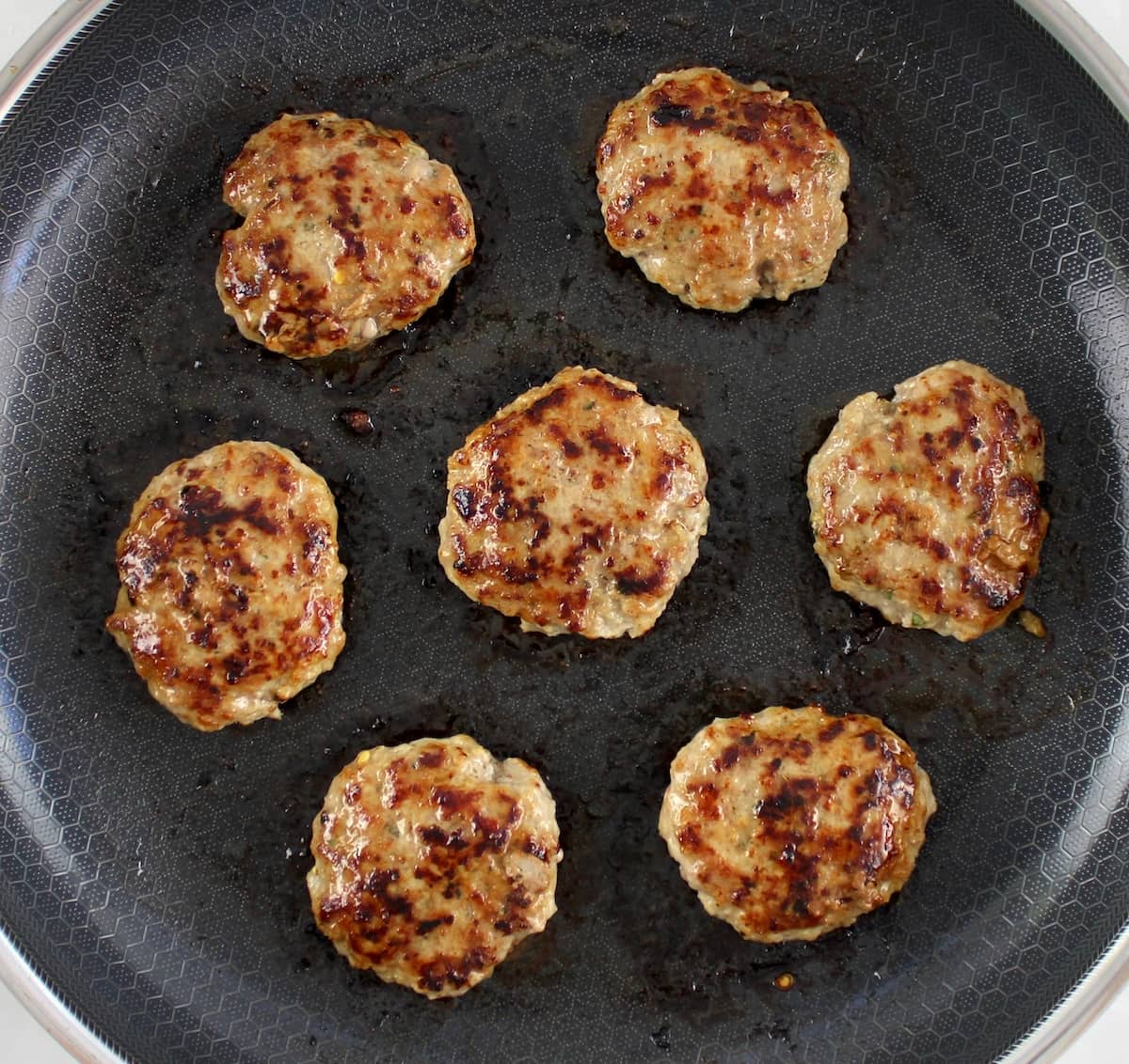 7 cooked Homemade Breakfast Sausage in skillet