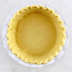 overhead view of Keto Pie Crust in white pie dish