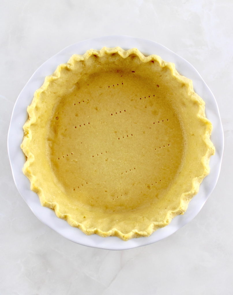 overhead view of Keto Pie Crust in white pie dish